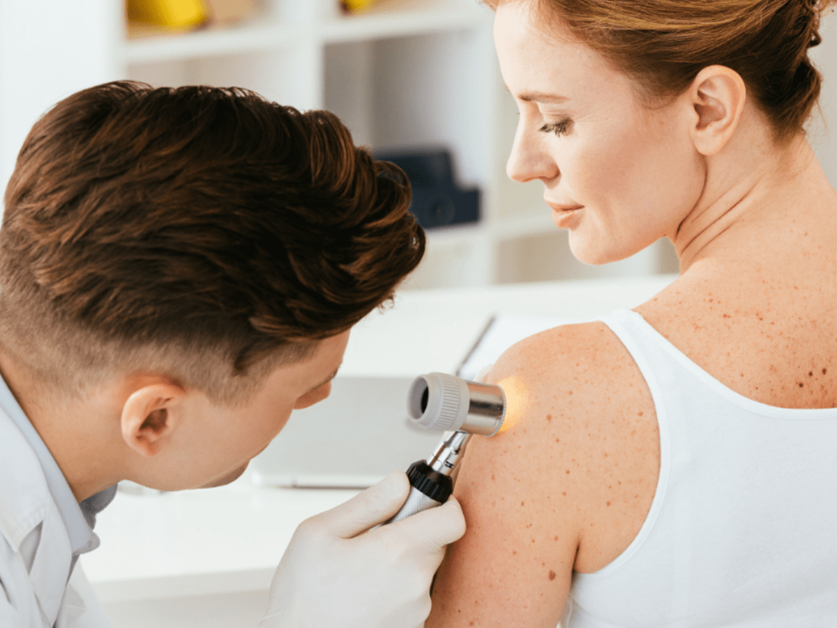 dermatologist examining a patient's shoulder